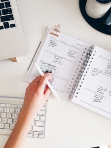 woman writing her plans in a notebook